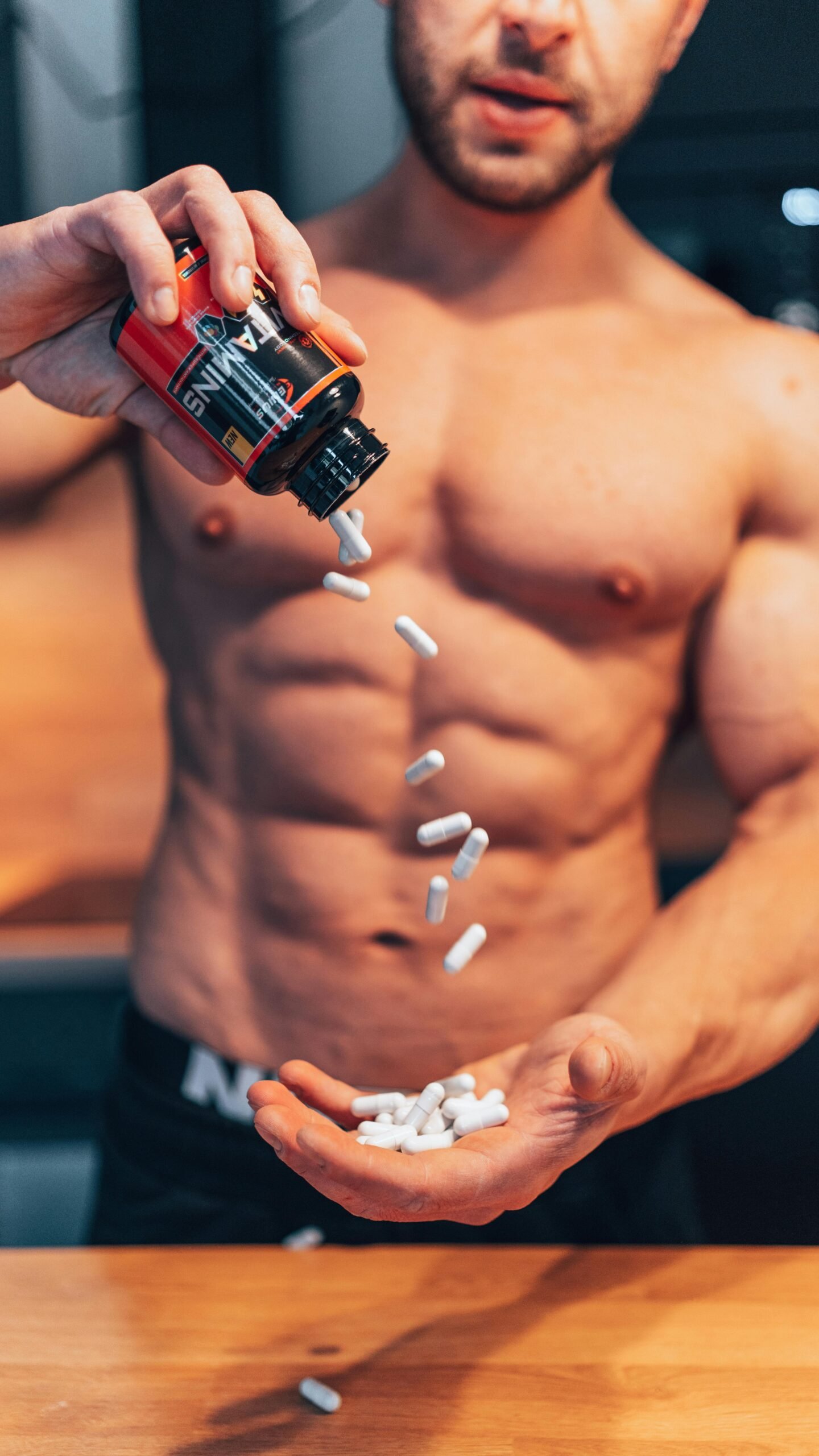 Home 11 Sporty man holding supplements and vitamins